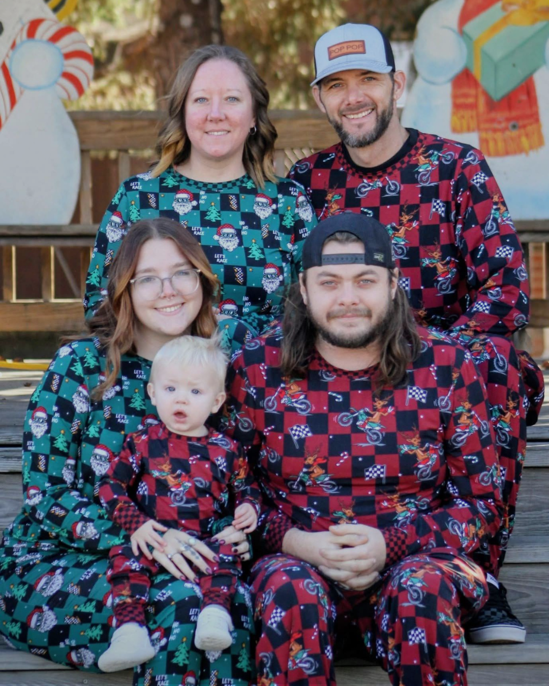Family of four wearing matching pajama sets in a festive pattern.