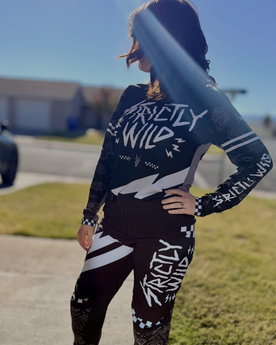 Person wearing a 'Strictly Wild' themed outfit with a blue sky and building in the background.